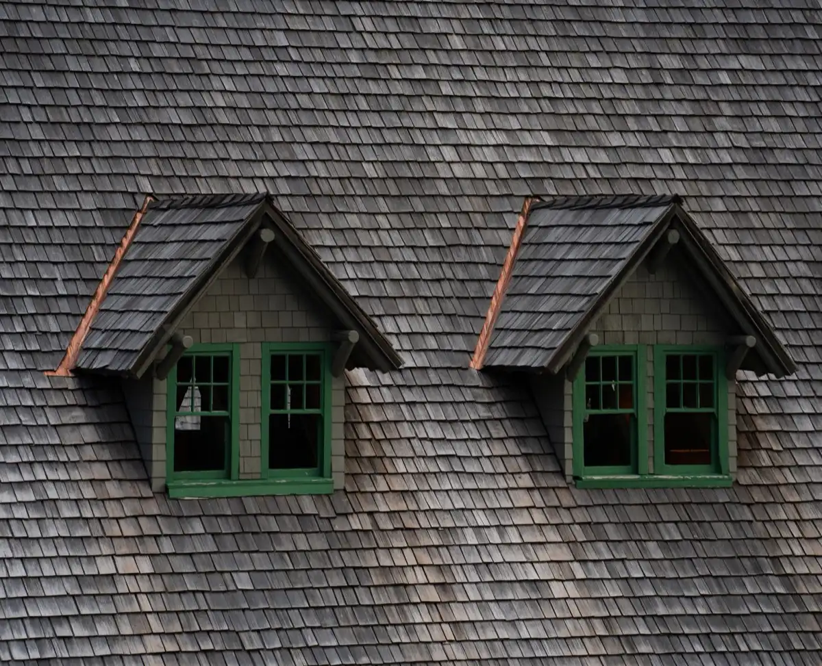 Dormers on a shingle roof in Champaign, IL, where step flashing and kickout flashing carry water past the walls